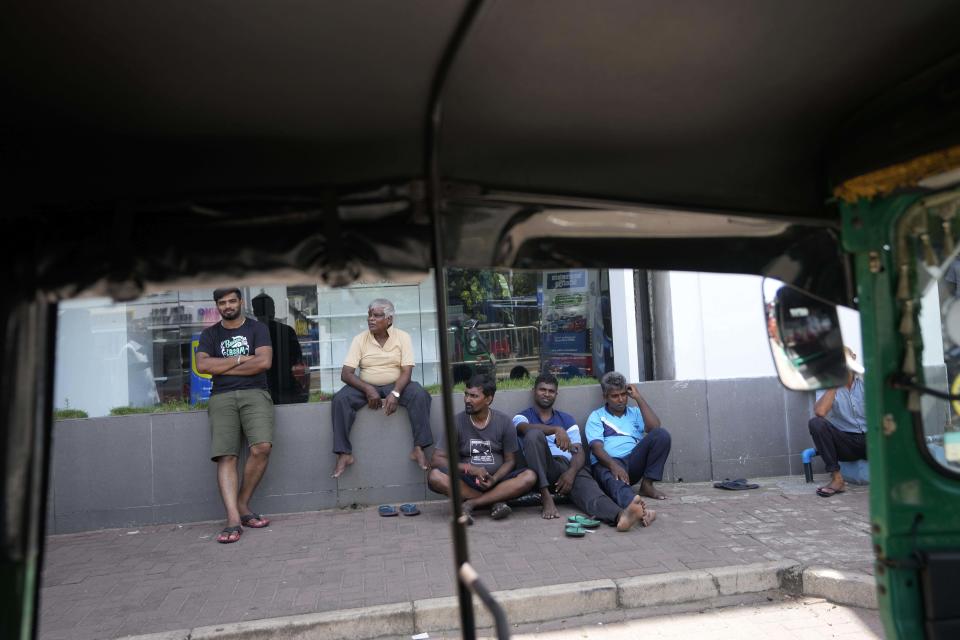 People wait to buy fuel at a fuel station in Colombo, Sri Lanka, Monday, June 27, 2022. Sri Lanka is sending two ministers to Russia to negotiate for fuel — one of the necessities that the Indian ocean island nation has almost run out of amid its ongoing economic crisis. (AP Photo/Eranga Jayawardena)