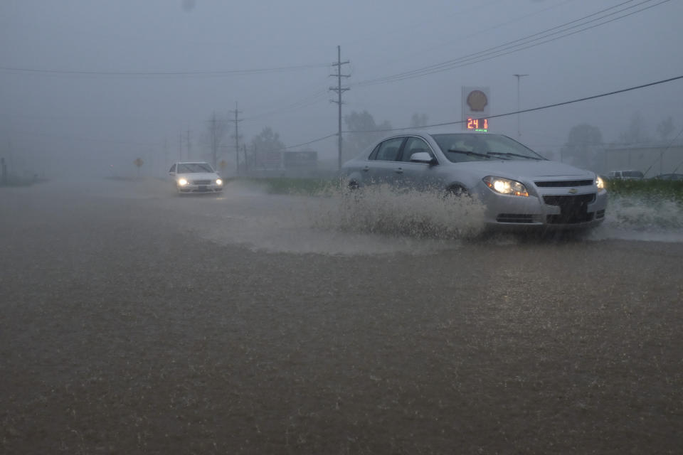 Vehicles travel through a flooded section of Highway 61 South following severe weather on Saturday, April 13, 2019 in Vicksburg, Miss. Authorities say a possible tornado has touched down in western Mississippi, causing damage to several businesses and vehicles. John Moore, a forecaster with the National Weather Service in Jackson, says a twister was reported Saturday in the Vicksburg area of Mississippi and was indicated on radar. (Courtland Wells/The Vicksburg Post via AP)