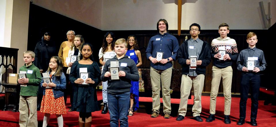 The group of top three winners in the Martin luther King Essay Contest for all four grade divisions is shown at the ceremony.