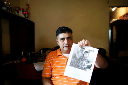 Melvin Garcia, 37, a deportee from the U.S. who was separated from his daughter Daylin Garcia, 12, at the McAllen entry point under the Trump administration's hardline immigration policy, shows a photo of his daughter during an interview with Reuters in Choloma, Honduras June 21, 2018. Picture taken on June 21, 2018. REUTERS/Carlos Jasso