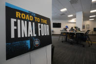 Workers wait to run errands for guests who are inside the bubble while in town for the NCAA men's college basketball tournament, Tuesday, March 30, 2021, in Indianapolis. The NCAA and local organizing groups set up expanded ambassador and item-delivery services relying on volunteer help to take care of needs for players, officials and others working inside. (AP Photo/Darron Cummings)