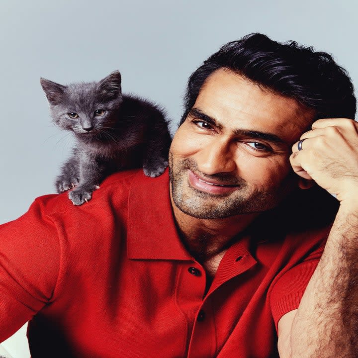 Kumail smiles as a kitten sits on his shoulder