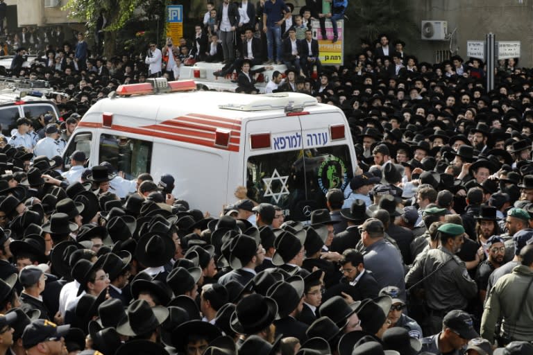 Police try to clear the way for the ambulance bearing Rabbi Shteinman's body at his funeral on December 12, 2017