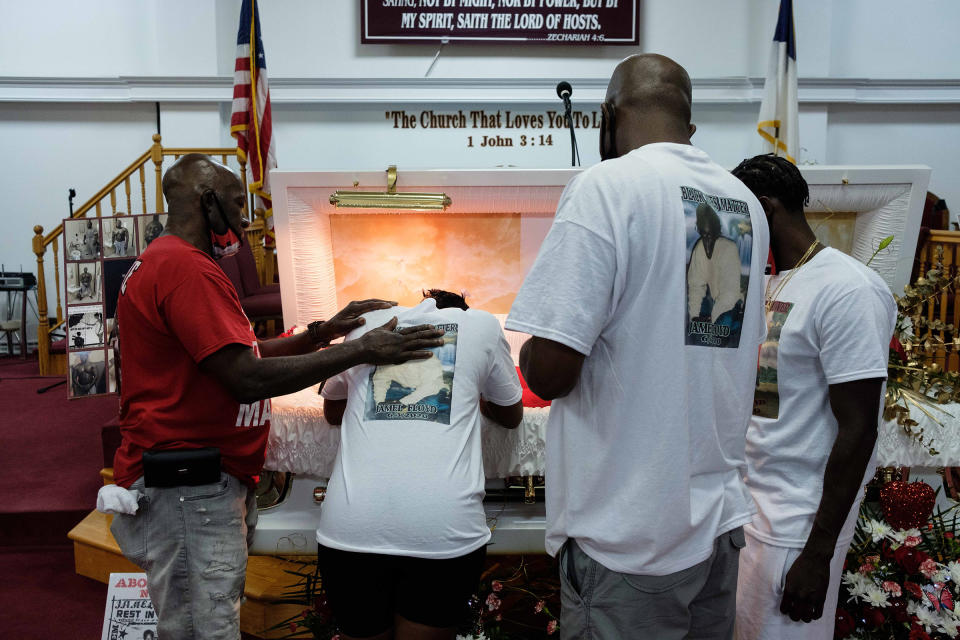 Ramel Floyd looks down at his older brother's body during the wake on June 29.<span class="copyright">Yuki Iwamura</span>