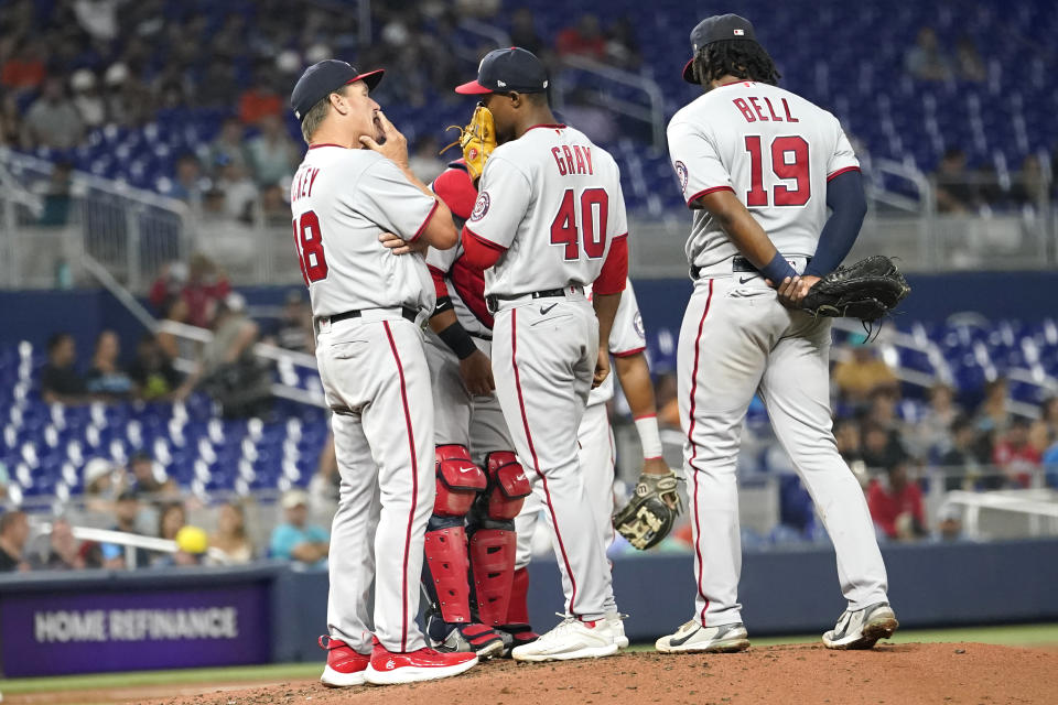 Washington Nationals pitching coach Jim Hickey (48) talks with starting pitcher Josiah Gray (40) during the third inning of a baseball game Miami Marlins, Wednesday, May 18, 2022, in Miami. (AP Photo/Lynne Sladky)