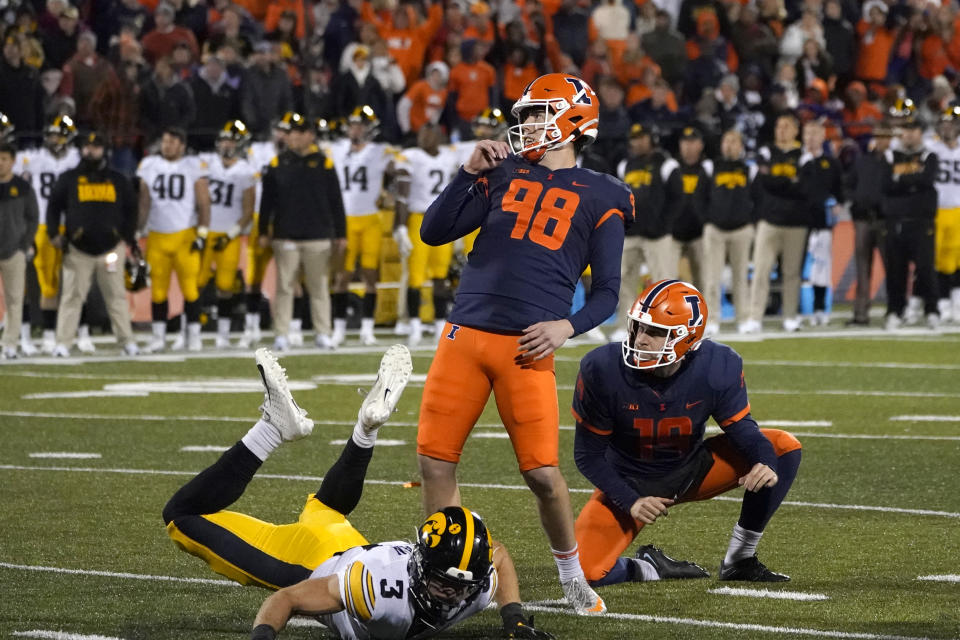 Illinois place kicker Fabrizio Pinton watches his go ahead field goal off the hold of Hugh Robertson during the second half of an NCAA college football game Saturday, Oct. 8, 2022, in Champaign, Ill. Illinois won 9-6. (AP Photo/Charles Rex Arbogast)