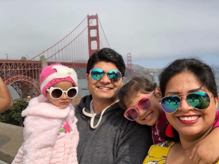 Poorva Dixit and her family pose for a photo in San Francisco, where both she and her husband worked prior to being separated