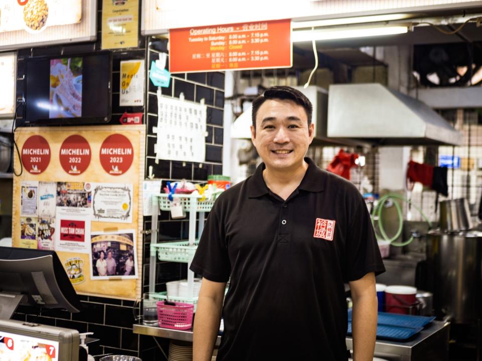 A man in front of a stall.