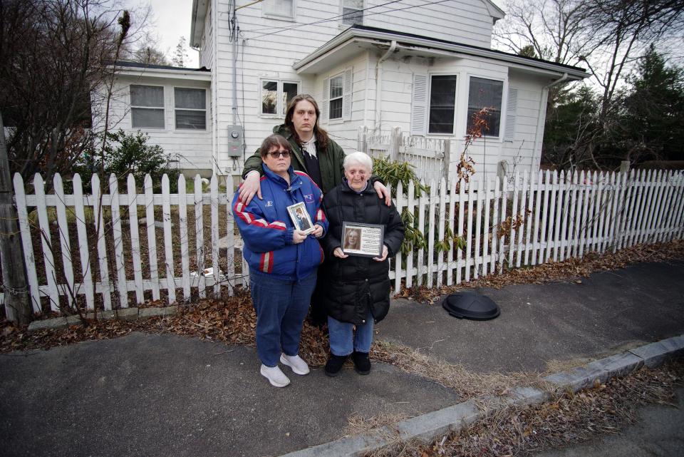 Melissa Shaw, her son Paul, and grandmother Barbara Dotolo, all of Brockton, stand at the spot on Thursday, March 16, 2023, where Linda Dotolo Connors, mother to Melissa, grandmother to Paul, and daughter to Barbara, was found burned to death on a Brockton street on April 23, 2003.