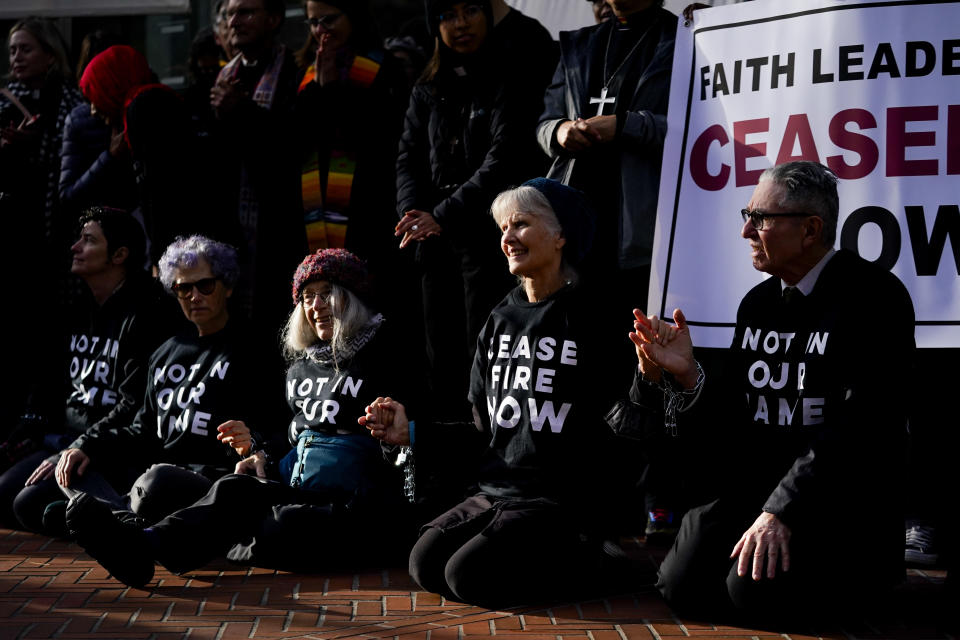 FILE - Demonstrators wear shirts reading: "Cease fire now" during a Jewish Voice for Peace rally that shut down the Henry M. Jackson Federal Building while demanding that Sen. Patty Murray, D-Wash., call for a ceasefire in the Israel-Hamas war on Nov. 3, 2023, in Seattle. As the Israel-Hamas war rages in Gaza, there's a bitter battle for public opinion flaring in the U.S., with angry rallies and disruptive protests at prominent venues in several major cities. Among the catalysts are Palestinian and Jewish-led groups that have been active for years in opposing Israeli policies toward the Palestinians. Now many groups involved in those earlier efforts are playing a key role protesting the latest fighting, with actions on campuses and beyond. (AP Photo/Lindsey Wasson, File)