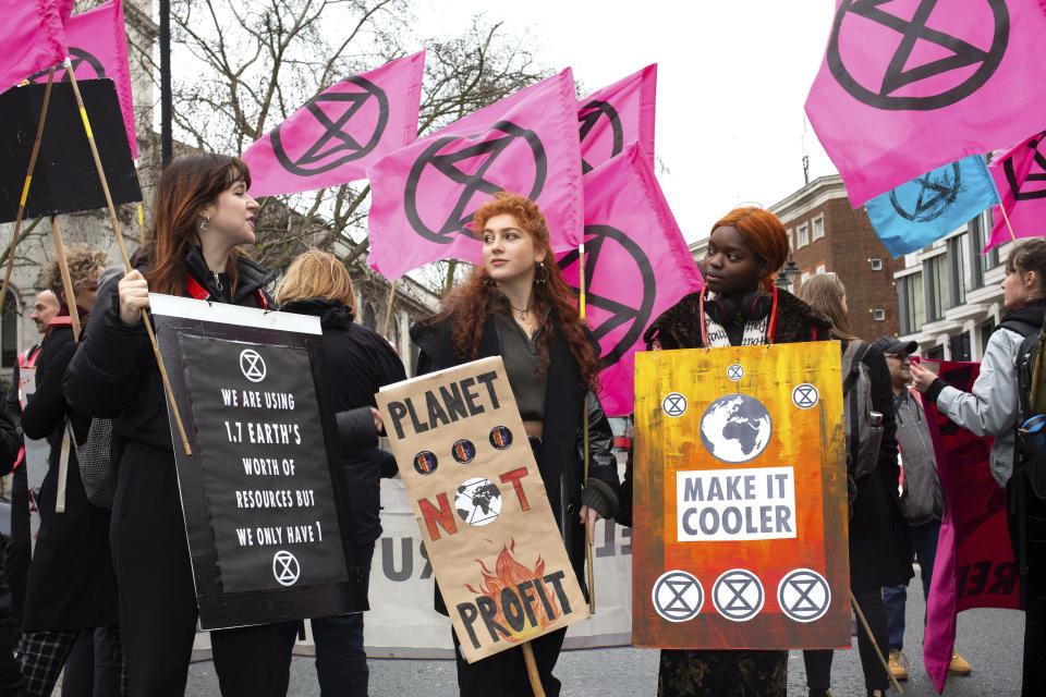 People gather in central London for an Extinction Rebellion protest during London Fashion Week, in London Saturday Feb. 15, 2020. The environmental pressure group Extinction Rebellion are targeting what they allege is the global impact from the ephemeral fashion industry.(Katie Collins/( / PA via AP)