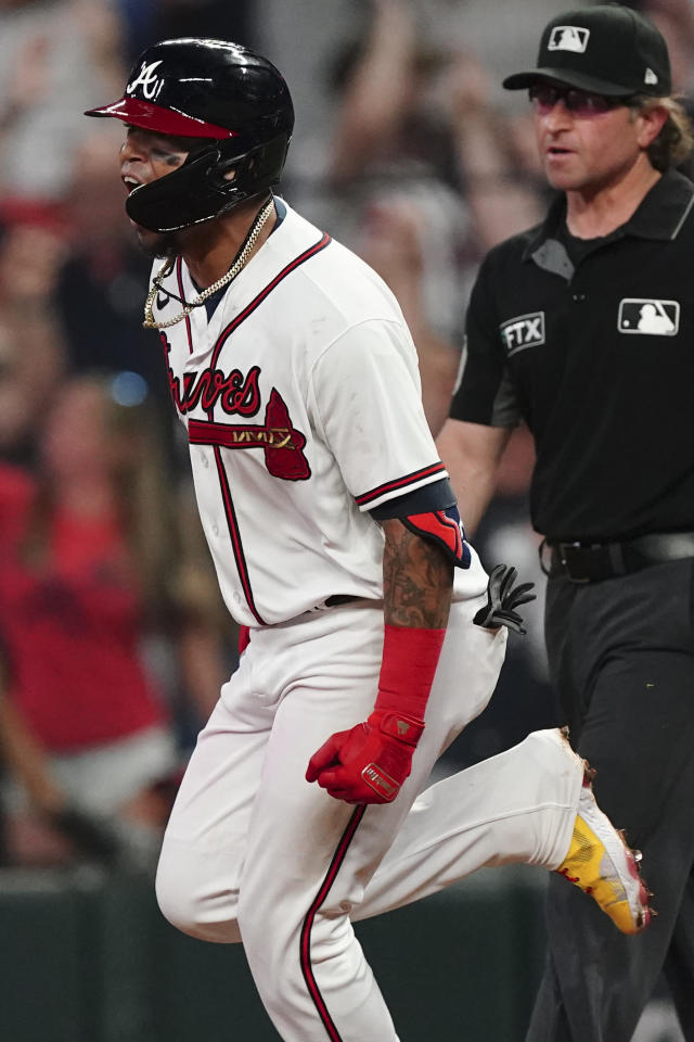 Atlanta Braves designated hitter Orlando Arcia is mobbed by