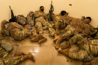 WASHINGTON, DC - JANUARY 13: Members of the National Guard sleep in the halls of Capitol Hill as the House of Representativs convene to impeach President Donald Trump, nearly a week after a pro-Trump insurrectionist mob breached the security of the nations capitol while Congress voted to certify the 2020 Election Results on Wednesday, Jan. 13, 2021 in Washington, DC. (Kent Nishimura / Los Angeles Times via Getty Images)