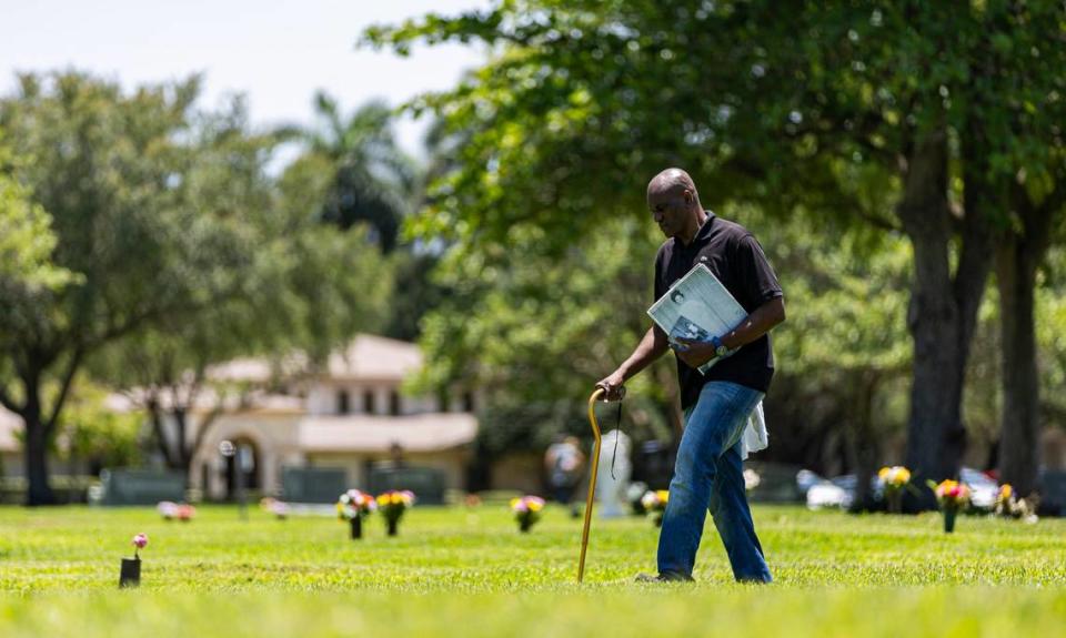 Augustin Lorfils, 53, visits Our Lady of Mercy Catholic Cemetery on Friday, May 10, 2024, in Doral, Fla. Lorfils’ mother and five siblings, who died a tragic death, are buried at the cemetery and he is now working to place headstones at their grave site.