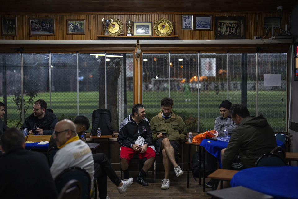 Amateur players have a rest in a tea room after playing a recreational soccer "Astroturf" match in Istanbul, Turkey, Tuesday, March 5, 2024. "Astroturf" matches in Turkey are usually 60 minutes and played 7 to 7 in half fields with no offside, no sliding tackles nor throw-ins. (AP Photo/Francisco Seco)