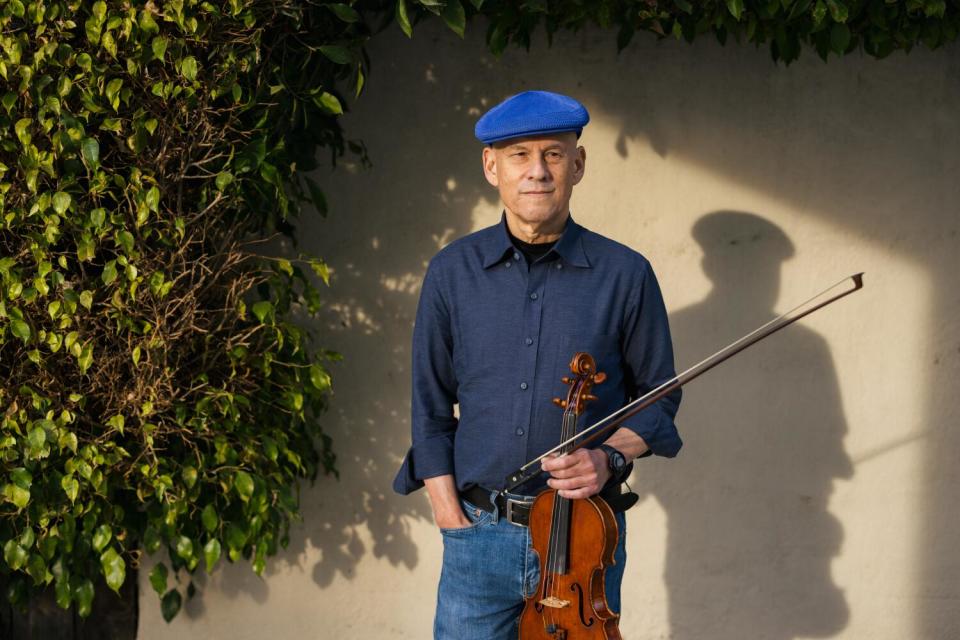 Marc Sazer poses with his violin.