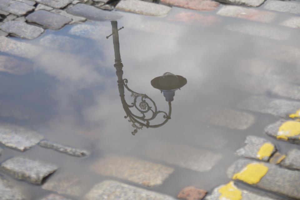 Lamp reflected in puddle