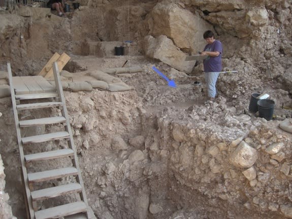 An arrow points to the Qesem Cave hearth, where hominins may have tended to fires as early as 300,000 years ago.