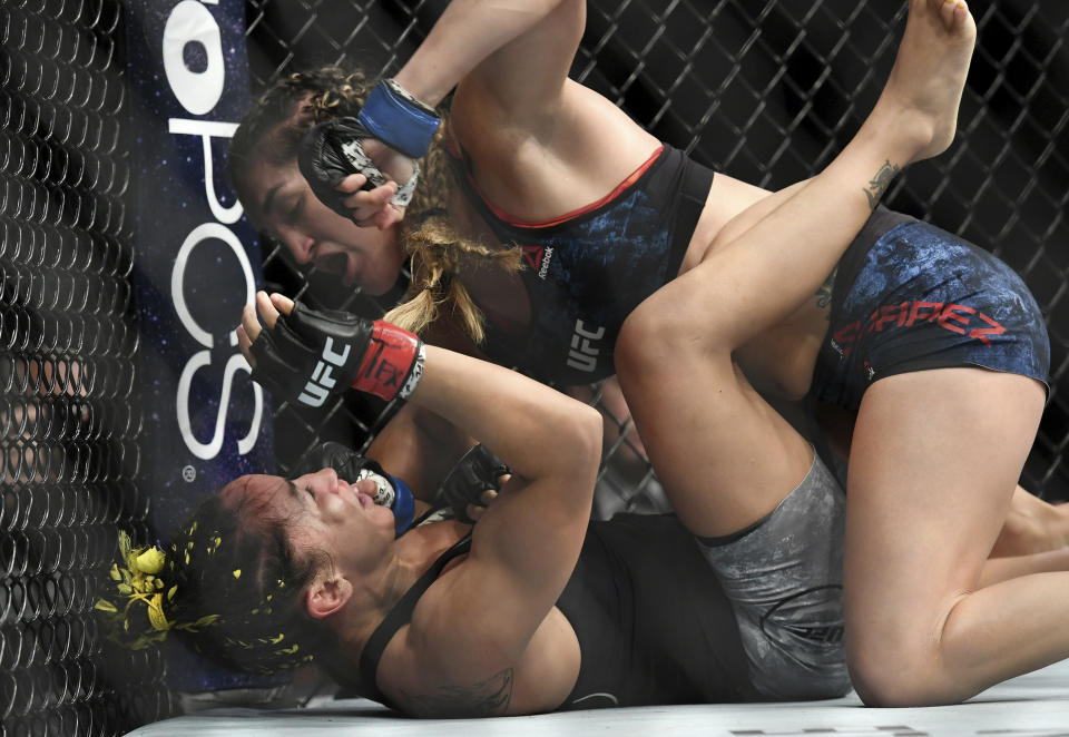 Tatiana Suárez, arriba, golpea a Carla Esparza durante su pelea de artes marciales mixtas de peso paja en UFC 228 el sábado 8 de septiembre de 2018 en Dallas.  (Foto AP/Jeffrey McWhorter)