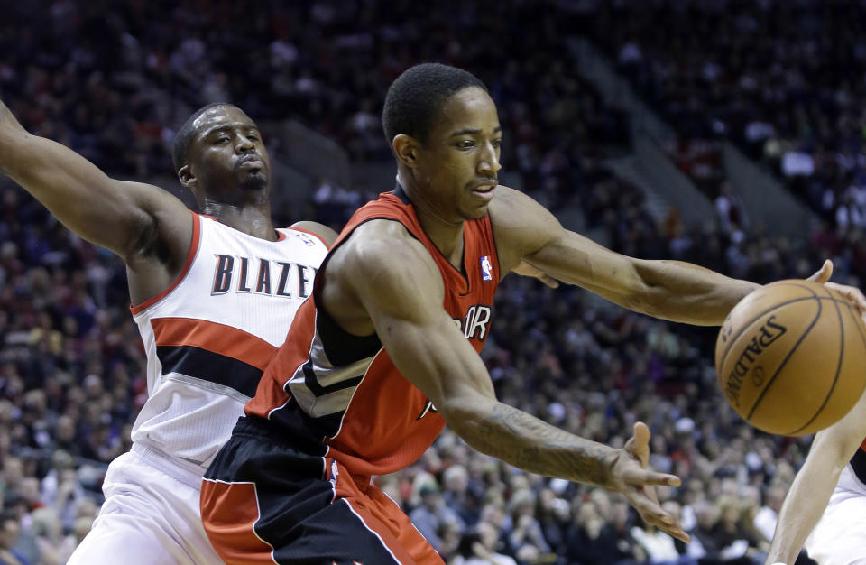 Toronto Raptors guard DeMar DeRozan, right, pulls in a loose ball as Portland Trail Blazers guard Wesley Matthews defends during the first half of an NBA basketball game in Portland, Ore., Saturday, Feb. 1, 2014.(AP Photo/Don Ryan)