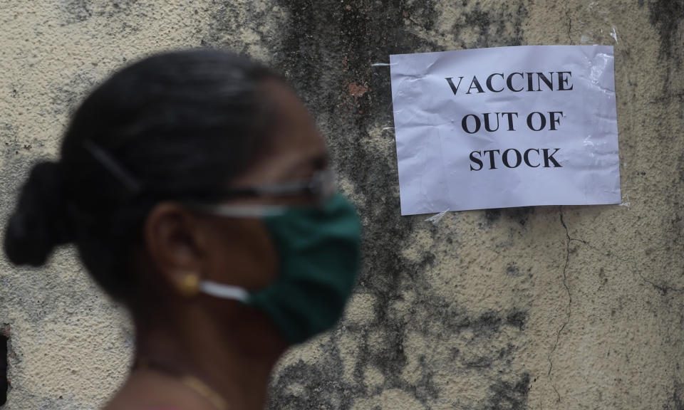 Una mujer camina frente a un letrero que informa sobre la escasez de la vacuna contra el coronavirus en Mumbai, India, el jueves 8 de abril de 2021. (AP Foto/Rafiq Maqbool)