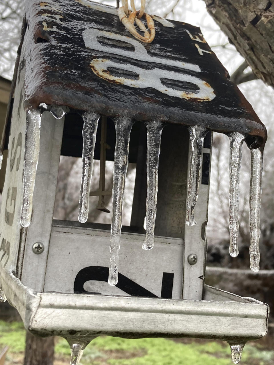 Ice coats a birdhouse at an Austin, Texas, home, Wednesday, Feb. 1, 2023. A storm knocked out power for a third of the city. Even as temperatures finally pushed above freezing in Austin — and were expected to climb past 50 degrees (10 Celsius) on Friday — the relief will be just in time for an Arctic front to drop from Canada and threaten northern states. (Andrea Ball/Houston Chronicle via AP)