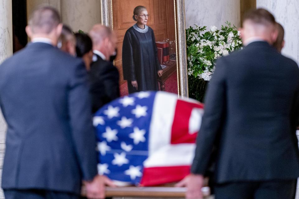 The flag-draped casket of Justice Ruth Bader Ginsburg, carried by Supreme Court police officers, arrives in the Great Hall at the Supreme Court in Washington, Wednesday, Sept. 23, 2020. Ginsburg, 87, died of cancer on Sept. 18. (AP Photo/Andrew Harnik, Pool)