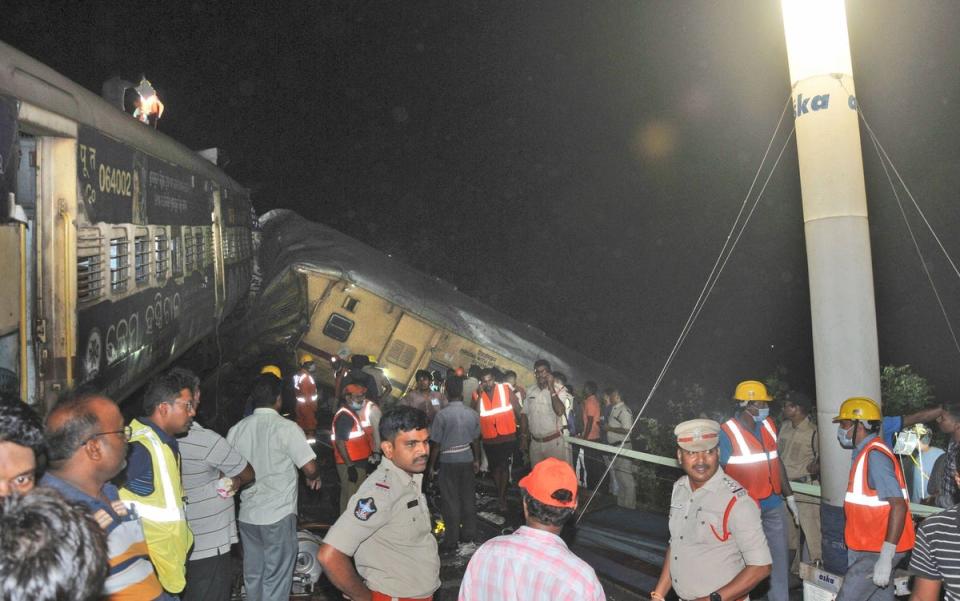 Rescuers at the scene on Sunday (AP)