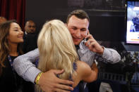 Johnny Manziel, from Texas A&M, reacts after being selected 22nd overall by the Cleveland Browns during the first round of the NFL football draft, Thursday, May 8, 2014, at Radio City Music Hall in New York. (AP Photo/Jason DeCrow)
