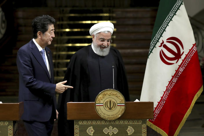 Japanese Prime Minister Shinzo Abe, left, and Iranian President Hassan Rouhani, attend a joint press conference after their meeting at the Saadabad Palace in Tehran, Iran, Wednesday, June 12, 2019. The Japanese leader is in Tehran on an mission to calm tensions between the U.S. and Iran. (AP Photo/Ebrahim Noroozi)