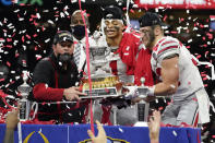 Ohio State head coach Ryan Day, from left, quarterback Justin Fields and linebacker Tuf Borland hold up the trophy after the team's win against Clemson in the Sugar Bowl NCAA college football game Friday, Jan. 1, 2021, in New Orleans. Ohio State won 49-28. (AP Photo/John Bazemore)