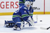 Vancouver Canucks goalie Casey DeSmith makes a save against the Montreal Canadiens during the second period of an NHL hockey game Thursday, March 21, 2024, in Vancouver, British Columbia. (Darryl Dyck/The Canadian Press via AP)
