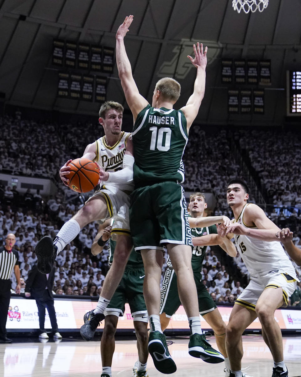 Purdue guard Braden Smith (3) makes a pass around Michigan State forward Joey Hauser (10) during the second half of an NCAA college basketball game in West Lafayette, Ind., Sunday, Jan. 29, 2023. Purdue defeated Michigan State 77-61. (AP Photo/Michael Conroy)