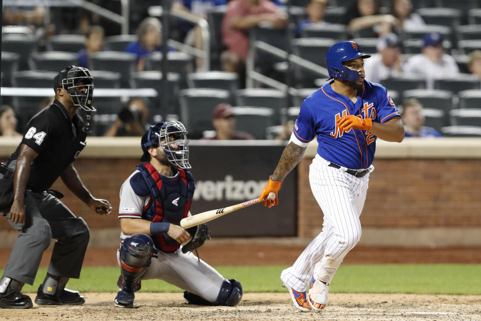 CORRECTS TO THREE-RUN HOME RUN NOT SOLO Home plate umpire Alan Porter and Atlanta Braves catcher Francisco Cervelli watch along with New York Mets' Dominic Smith as Smith's walk-off three-run home run sails over the outfield fence in a baseball game, Sunday, Sept. 29, 2019, in New York. (AP Photo/Kathy Willens)