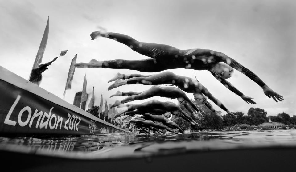 LONDON, ENGLAND - AUGUST 04: (EDITORS NOTE: Image has been converted to black and white.) Athletes begin the swimming leg of the Women's Triathlon on Day 8 of the London 2012 Olympic Games at Hyde Park on August 4, 2012 in London, England. (Photo by Adam Pretty/Getty Images)