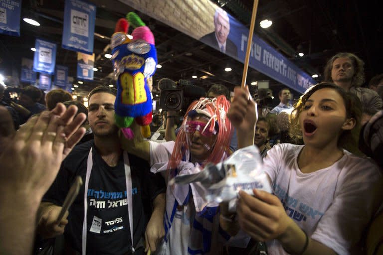 Israeli Likud Party supporters celebrate after the exit polls were announced on January 22, 2013 at the party's headquarters in Tel Aviv. Israeli Prime Minister Benjamin Netanyahu's Likud-Beitenu list was the top vote getter in today's election but the rightwing combination was weakened by a strong showing by the centrist Yesh Atid, according to TV exit polls