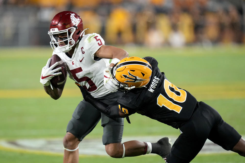 Arizona State defensive back Ed Woods (10) brings down Washington State wide receiver Lincoln Victor (5) during the second half of an NCAA college football game Saturday, Oct. 28, 2023, in Tempe, Ariz. (AP Photo/Ross D. Franklin)