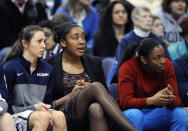 Briana Pulido, Morgan Tuck and Brianna Banks, left to right, watch action during the second half of Connecticut's 81-53 victory over South Florida in an NCAA college basketball game in Hartford, Conn., Sunday, Jan. 26, 2014. (AP Photo/Fred Beckham)