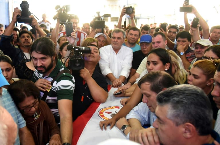 Relatives mourn Rodrigo Quintana, leader of Paraguay's opposition Liberal Party youth branch, apparently shot by police as they searched the party's offices in Asuncion