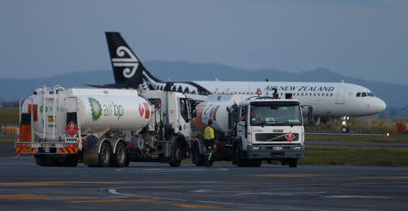 An Air New Zealand aircraft passes a fuel truck on the tarmac of Auckland Airport during fuel shortages in New Zealand, September 20, 2017. REUTERS/Nigel Marple