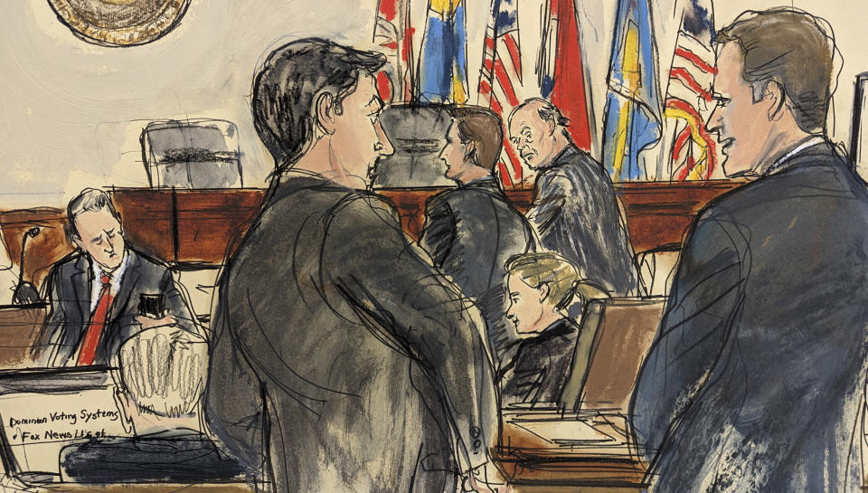 This artist sketch depicts Dominion Voting Systems attorney Justin Nelson, standing third from right, conferring with Fox News attorney Daniel Webb, standing second from right, as lawyers waited in Delaware Superior Court Tuesday afternoon, April 18, 2023, in Wilmington, Del. Soon after, Judge Eric Davis announced Fox News and Dominion Voting Systems had reached a settlement in the voting machine company's defamation lawsuit. Additional Dominion Voting Systems attorneys stand in the foreground. (Elizabeth Williams via AP)