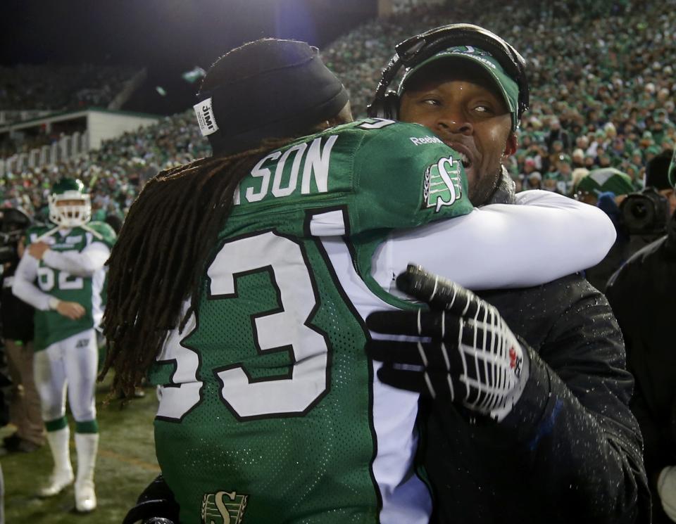 Saskatchewan Roughriders head coach Corey Chamblin is embraced by Dwight Anderson (33) on the sidelines in the closing moments of the team's win over the Hamilton Tiger Cats in the CFL's 101st Grey Cup championship football game in Regina, Saskatchewan November 24, 2013. REUTERS/Todd Korol (CANADA - Tags: SPORT FOOTBALL)