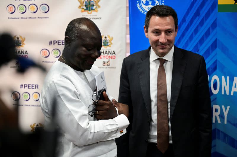 FILE PHOTO: Ghana's Finance Minister Ken Ofori-Atta stands next to Stephane Roudet, IMF Mission Chief for Ghana in Accra