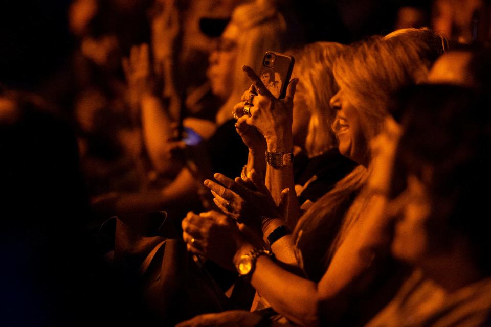 An audience member with an Elvis phone case records as Mike Deasy, a member of the Wrecking Crew who played both on recording sessions and in the band for the 1968 television special, performs during the Conversations on Elvis event at Graceland Soundstage as a part of Elvis Week 2023 in Memphis, Tenn., on Tuesday, August 15, 2023.