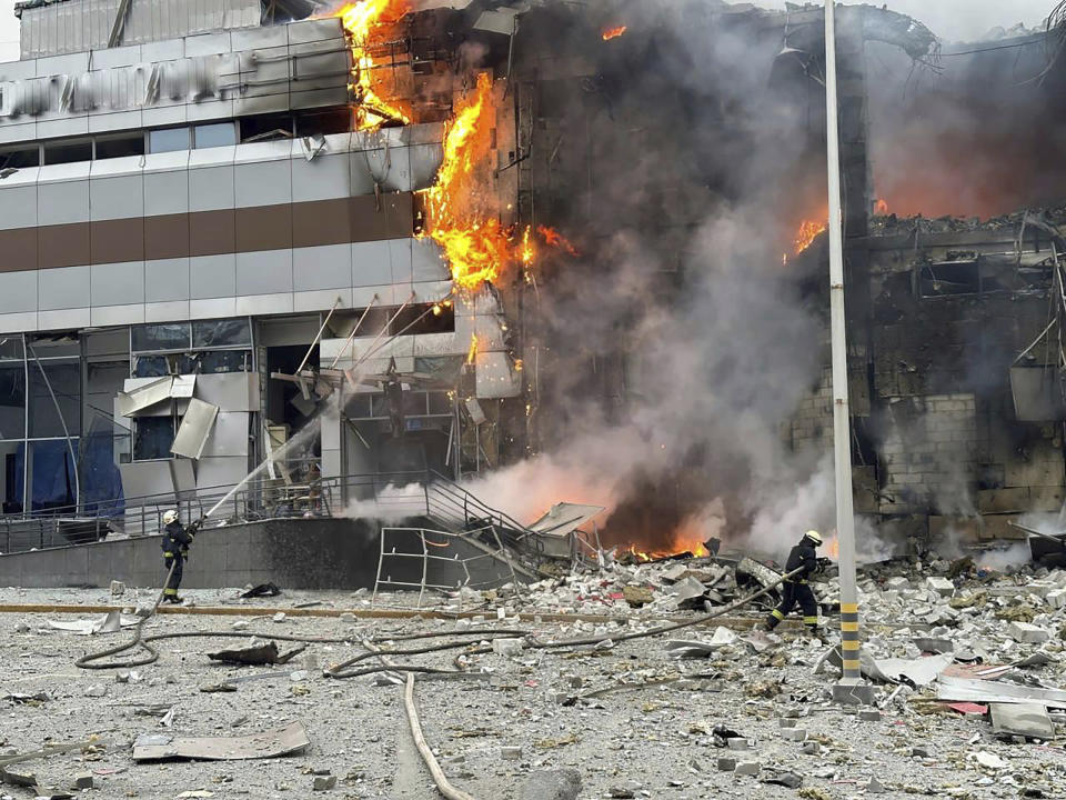 In this photo provided by the Ukrainian Emergency Service, firefighters work on the site of a building damaged after a Russian attack in Kyiv, Ukraine, Friday, Dec. 29, 2023. (Ukrainian Emergency Service via AP)