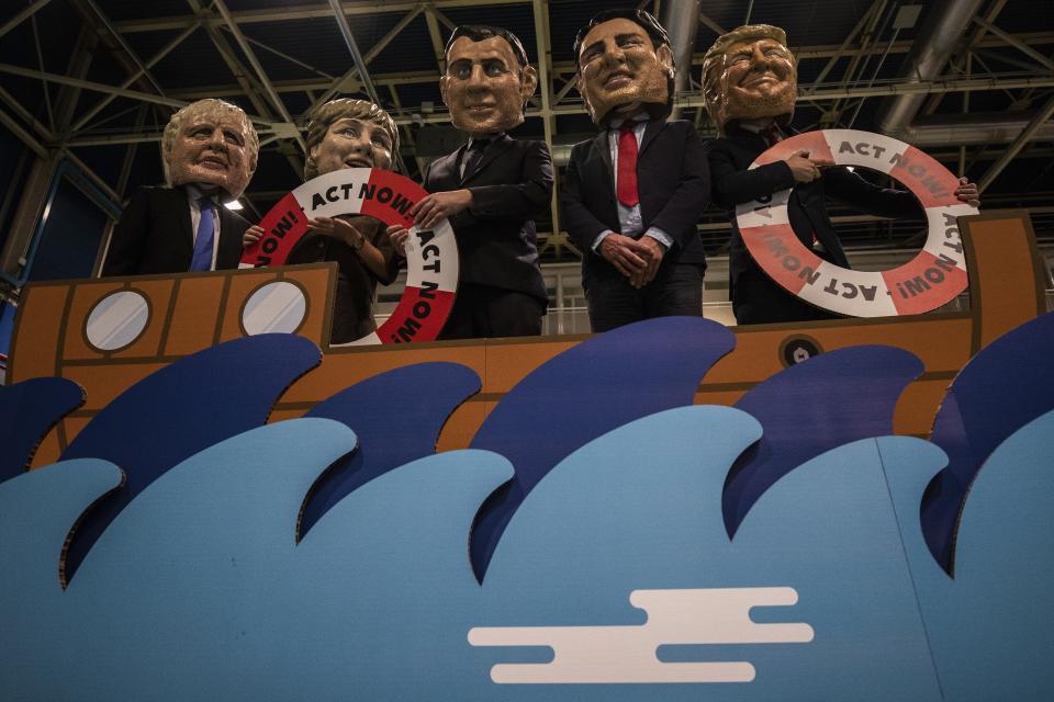 From left to right: activists of Oxfam International depicting Britain's Prime Minister Boris Johnson, German Chancellor Angela Merkel, French President Emmanuel Macron, Canadian Prime Minister Justin Trudeau and US President Donald Trump stage a stunt highlighting global warming and the rise of sea levels at the COP25 summit in Madrid, Tuesday Dec. 10, 2019. (AP Photo)