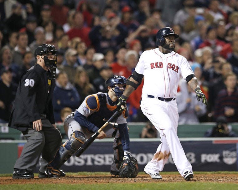 Boston Red Sox's David Ortiz hits a grand slam home run in the eighth inning during Game 2 of the American League baseball championship series against the Detroit Tigers Sunday, Oct. 13, 2013, in Boston. (AP Photo/Elise Amendola)