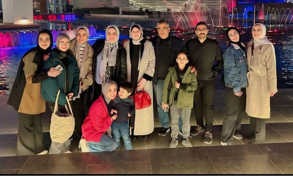 Sara Shannan (top row, fourth from left) poses with her parents, eight siblings and son during a January trip to Egypt to begin the immigration process. "For a fleeting moment, the scars of war vanished," she wrote in a journal entry.