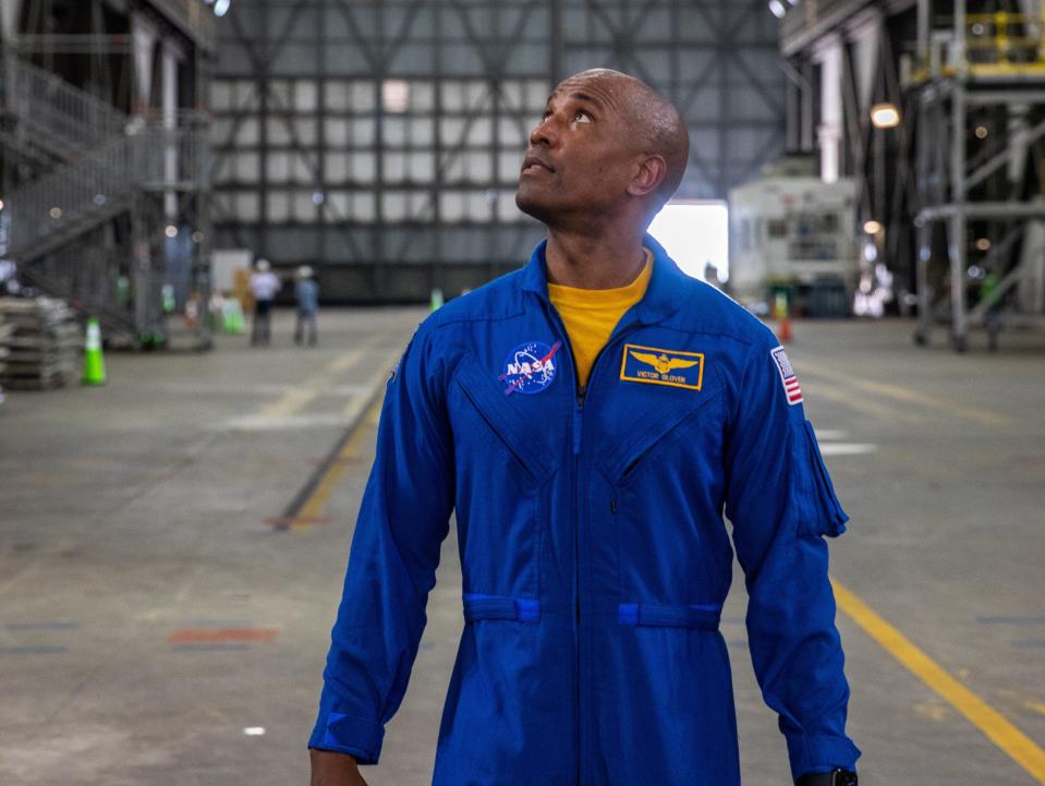 nasa astronaut victor glover looks up inside a rocket assembly building