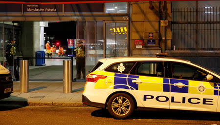 Police officers stand at the end of a tram platform following a stabbing at Victoria Station in Manchester, Britain, January 1, 2019. REUTERS/Phil Noble